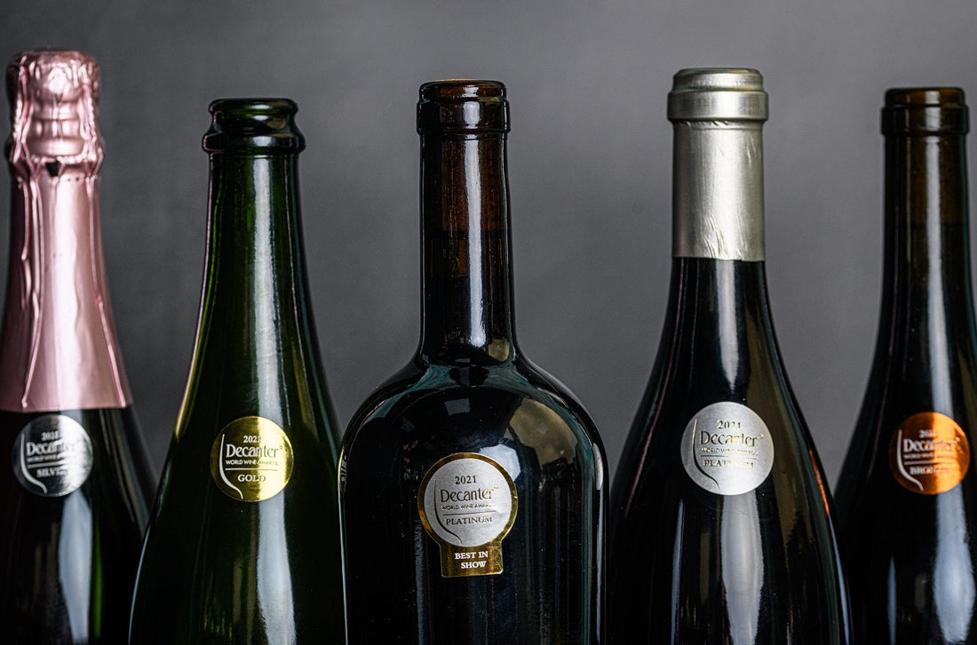 4 exclusive bottles in a row from decanter wine world awards each bottle has a decanter logo on it