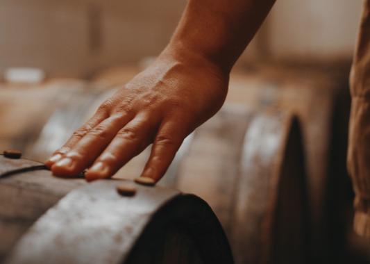 Hand on cask of champagne